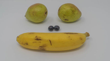 Studio shot of a fruit face, with pears, blueberries and a banana
