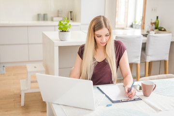 Young beautiful girl with a laptop at home