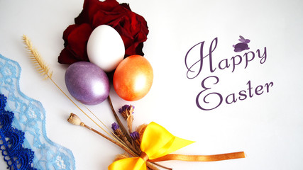 lilac, gold, pink egg, the dried red  rose, inscription of "happy Easter"