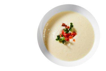 Creamy fish soup with salmon, potatoes, onions, cauliflower and carrots isolated on white background. with copy space. top view