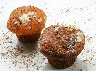 Chocolate and vanilla muffin over a white background