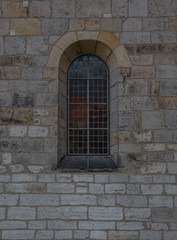 The old and ancient window in stone wall