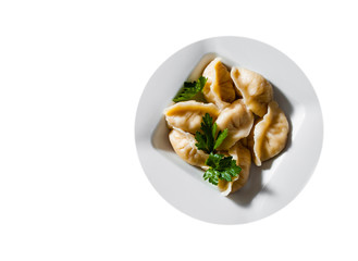 Meat dumplings - russian pelmeni, ravioli with meat on plate isolated on white background. with copy space. top view