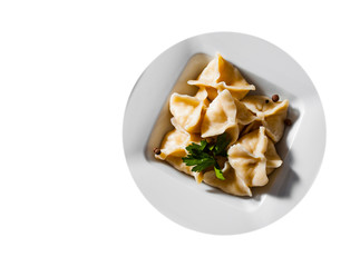 Meat dumplings - russian pelmeni, ravioli with meat on plate isolated on white background. with copy space. top view