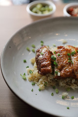 Nasi goreng fried rice with chicken on wood background