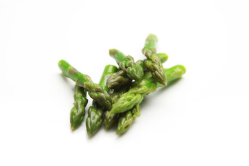 Fresh group of asparagus over a white background