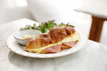 Sandwich ham and cheese on white table in coffee shop