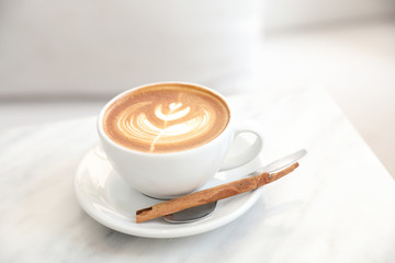 cappuccino or Latte art coffee made from milk on the white table in coffee shop