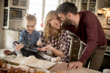Happy family making pasta in the kitchen at home
