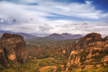 Landscape of monasteries of Meteora in Greece in Thessaly at the early morning. Cliffs of Meteora opposite a morning cloudy sky background