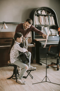 Cute little girl with guitar teacher
