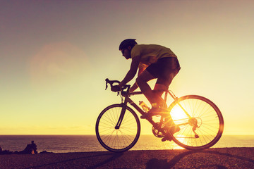 Road biking cyclist man training on bike professional cycling athlete riding racing bicycle in...
