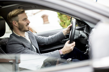 Young man driving in the modern car