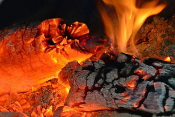 Fototapeta premium Fire burning from a log in the home fireplace. The firewood burns in the oven and gives heat.