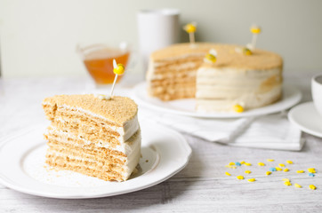 Honey cake on a wooden background with bees decorations