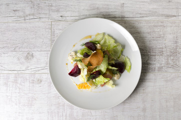 Salad of baked beet with fruits and raw meat