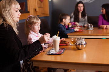 Mom and daughter enjoying life in the cafe