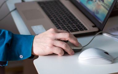 Man's hand holding a mouse for office work