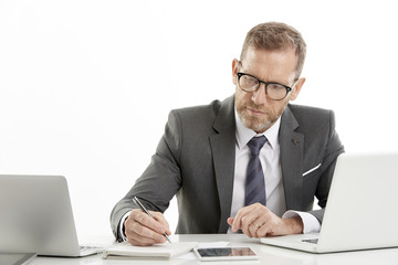 Businessman using laptops while working against white isolated background.