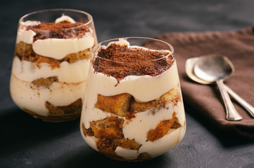 Homemade tiramisu cake in glasses, italian dessert.