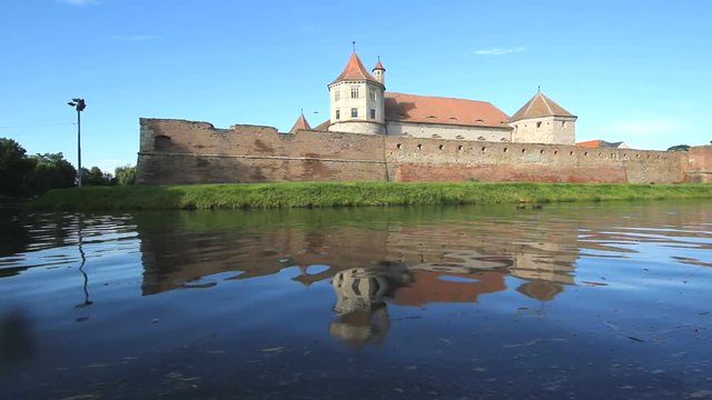 Fagaras fortress mirrored in the surrounding waters