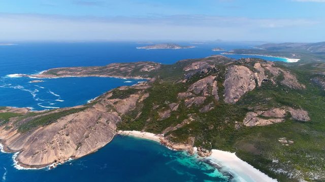 Aerial view of picturesque coastline of Hellfire Bay, colorful cliffs and rocks protruding above crystal clear waters of Southern Ocean - Cape Le Grand, Esperance, Western Australia from above, 4k UHD