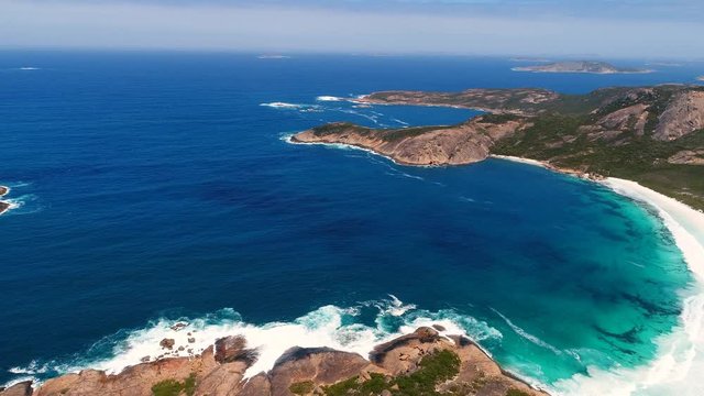 Aerial view of picturesque coastline of Hellfire Bay, colorful cliffs and rocks protruding above crystal clear waters of Southern Ocean - Cape Le Grand, Esperance, Western Australia from above, 4k UHD