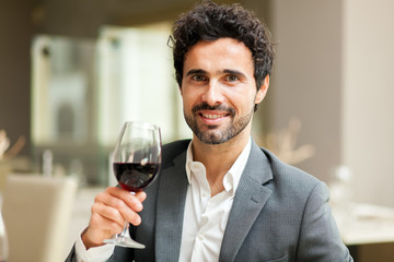 Man holding a glass of red wine