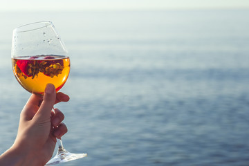 Frozen strawberry sangria cocktail at the edge of the sea.