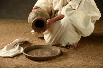 Fototapeta na wymiar Jesus pouring water