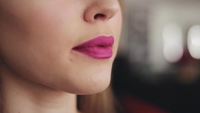 Close up of young fashion woman biting red lips sensual