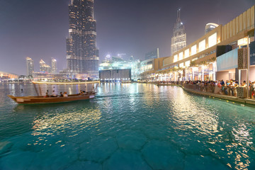 DUBAI, UAE - DECEMBER 4, 2016: Night view of Downtown buildings near Burj Khalifa. Dubai attracts 30 million tourists annually