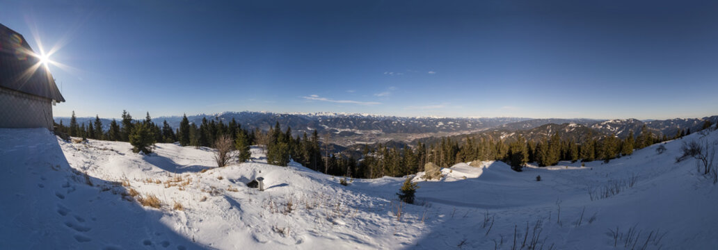Wide panoramia from snowy summit of mountain Rennfeld with hut