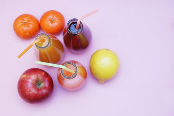 Bottles of Juice over Pink Background. Healthy diet concept. vitamine. top view.