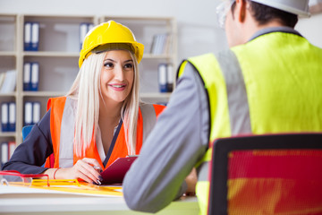 Construction workers having discussion in office before starting