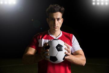 Good looking footballer with soccer ball