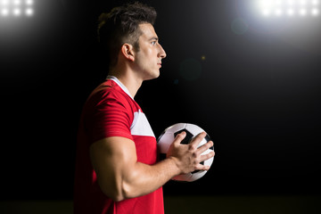 Soccer player with football in hand - Powered by Adobe