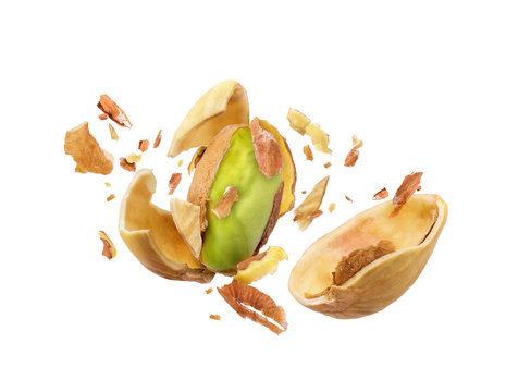 Pistachio is torn to pieces closeup isolated on white background