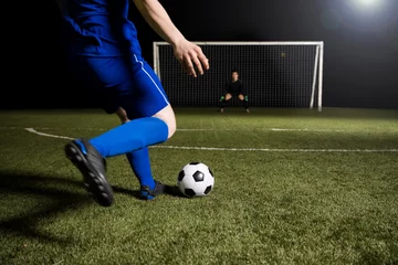 Zelfklevend Fotobehang Soccer player making a kick towards the goal © AntonioDiaz