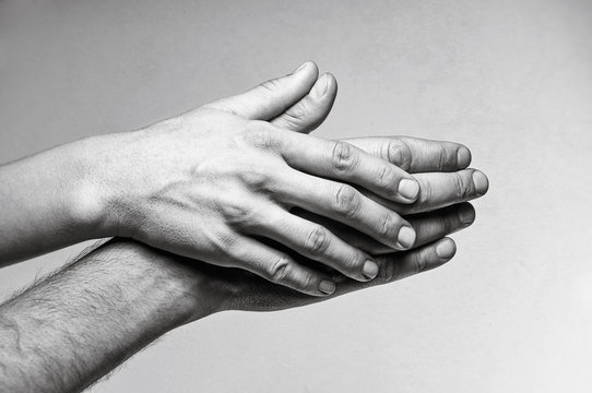 Concept of caring, tenderness, protection. Male and female hands touch each other.