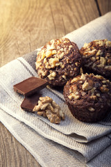 Homemade delicious chocolate Muffins with Walnut on wood backround