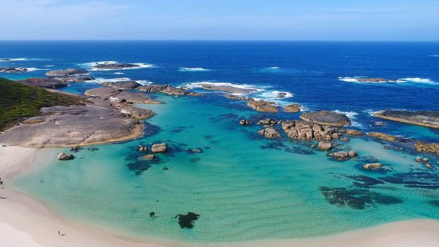 Aerial view of Greens Pool, white sand beach and typical rounded rock boulders in crystal clear turquoise water of Great Southern Ocean - Western Australia from above, 4k UHD