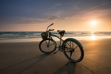 Sun set time with the bicycle on the beach