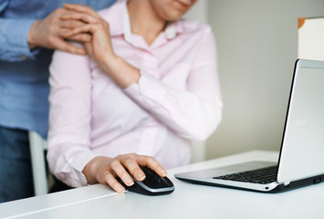 Sexual harassment at work. Man touching secretary's shoulder.