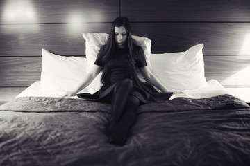 Young sexy woman on a bed in hotel