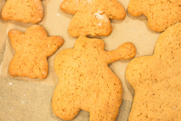 Ginger biscuits lie on a baking sheet. Cookies on baking paper. Selective focus.