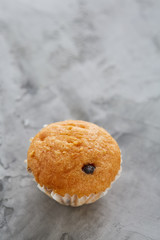 Tasty muffins arranged in pattern on light textured background, close-up, shallow depth of field, selective focus.