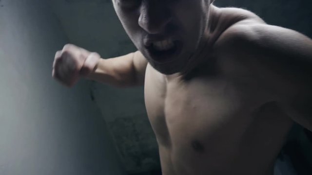 furious aggressive man beats with his fists the lying person