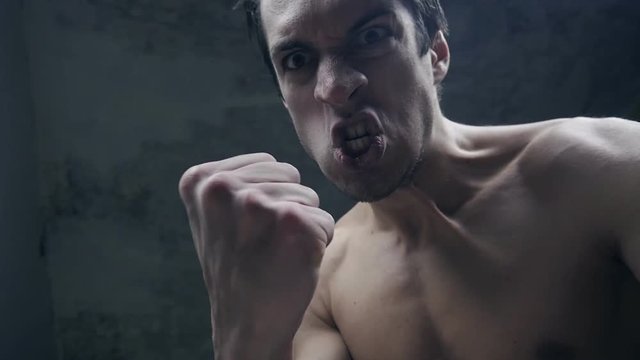 furious aggressive man beats with his fists the lying person