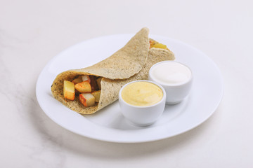 Vegetarian masala dosa with potato, chutney and sambar sauces.